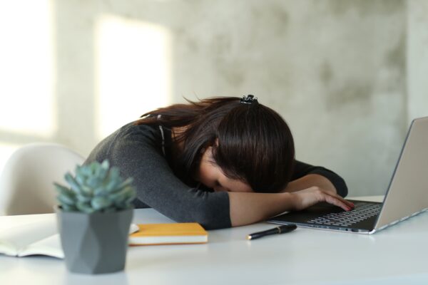 A person experiencing physical symptoms of vitamin B12 deficiency such as fatigue and weakness 