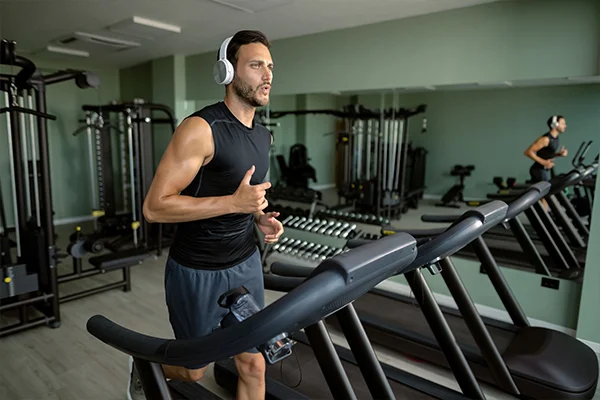 A person running on a treadmill to lose weight