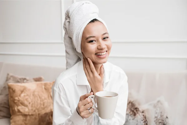 A person drinking garcinia cambogia tea and looking happy