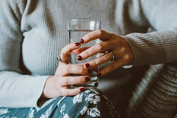 A captivating visual featuring a woman drinking a glass of liquid collagen from PatchMD - Vitamin Patches and Supplements. The image is used in the post titled 'Unlocking the Benefits of Collagen Weight Loss' by PatchMD. It serves as a symbolic representation of the potential benefits of liquid collagen for weight loss. The photograph showcases the woman actively engaging with liquid collagen, suggesting its role in supporting weight management. It invites readers to explore the benefits discussed in the post and consider incorporating liquid collagen supplements into their weight loss journey.