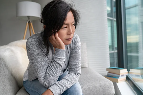 Image featured in the 'What Are the 34 Symptoms of Menopause: What You Need To Know' post for PatchMD - Vitamin Patches and Supplements, showing a woman in her 50s discussing common misconceptions about menopause.