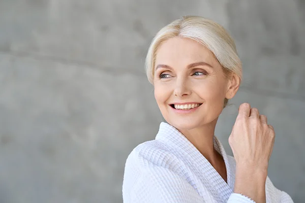 Image featured in the 'What Are the Signs of Coming to the End of Menopause?' post for PatchMD - Vitamin Patches and Supplements, illustrating a woman in her late 40s or early 50s making lifestyle adjustments to manage post-menopause symptoms.