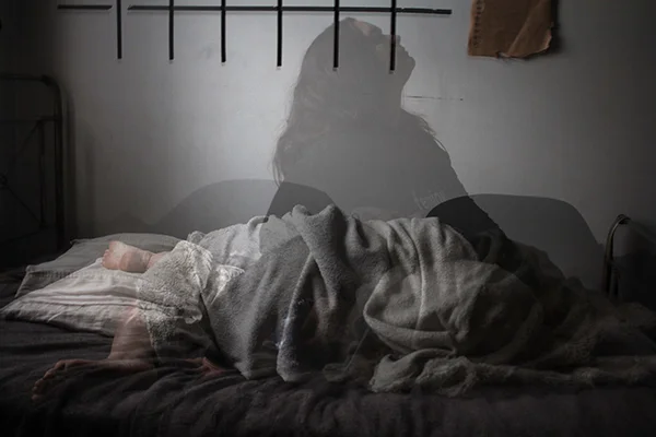 Image of a woman sleeping in a comfortable bed, relevant to the blog post titled 'Can I Take Melatonin While Pregnant: Is It Safe?' by PatchMD - Vitamin Patches and Supplements.