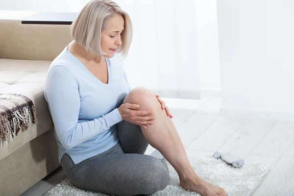 Visual representation for the 'Managing Menopause and Joint Pain: A Practical Guide' post by PatchMD - Vitamin Patches and Supplements. Depicts a woman experiencing joint pain as a symptom of menopause