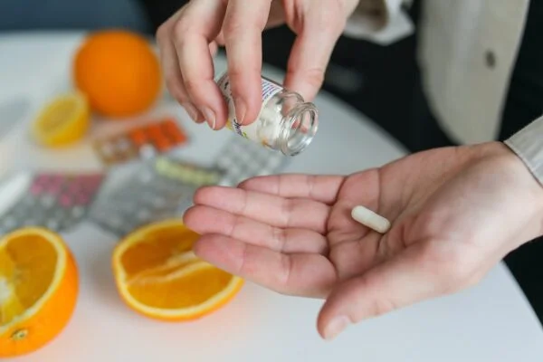 A person taking a vitamin B12 supplement to prevent stroke and coronary artery disease