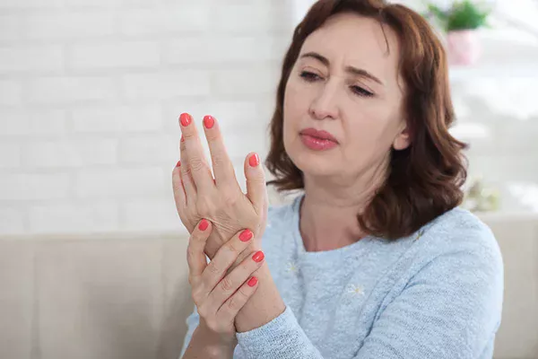 Visual representation for the 'Managing Menopause and Joint Pain: A Practical Guide' post by PatchMD - Vitamin Patches and Supplements. Features an image of a woman experiencing joint pain, highlighting the connection between menopause and joint discomfort