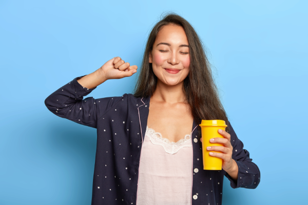 A person holding a bottle of magnesium citrate with a label showing the mineral content