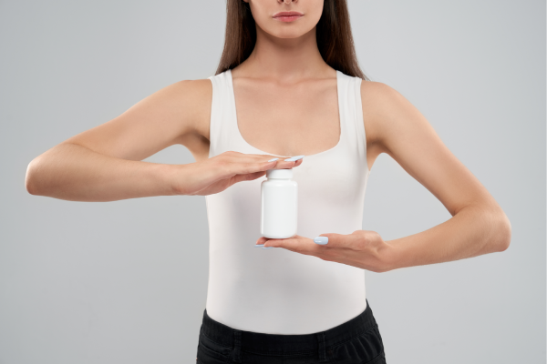 A person holding a bottle of magnesium supplement