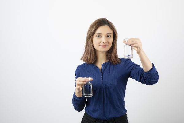 A person holding a bottle of magnesium supplement with a label showing the mineral content