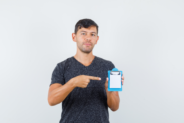 A person holding a bottle of magnesium supplement with a label showing the safety information