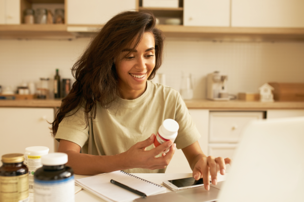 A person holding a bottle of magnesium supplements